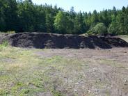 Ground yard waste pile that will get mixed with the bio-solids from the pit